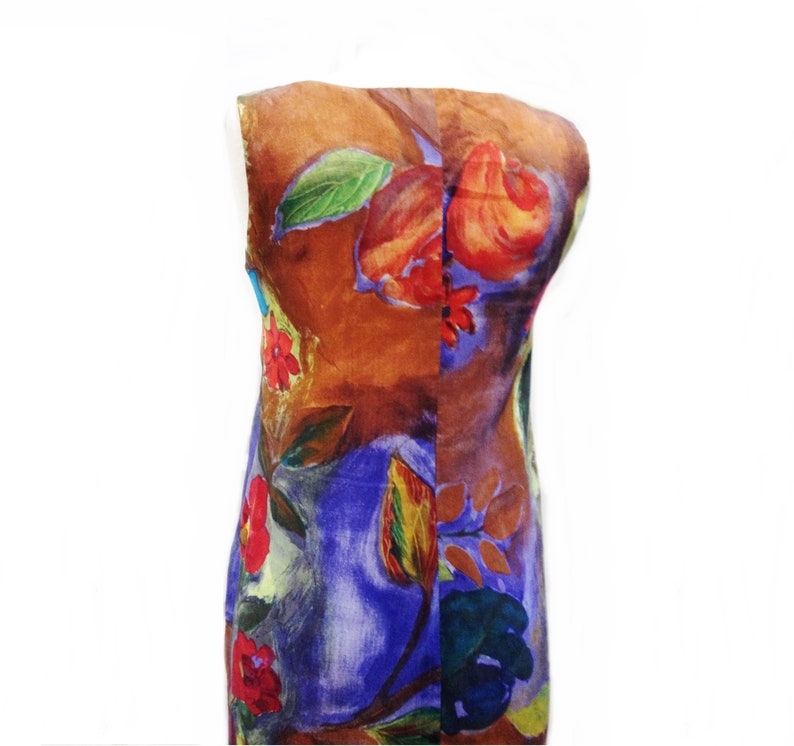 May include: A sleeveless dress with a colorful floral print. The dress has a brown background with red, orange, yellow, green, blue, and purple flowers.