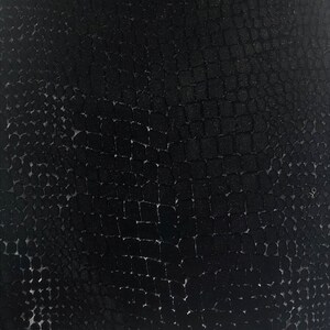 May include: Black textured fabric with a repeating pattern of small squares and circles.
