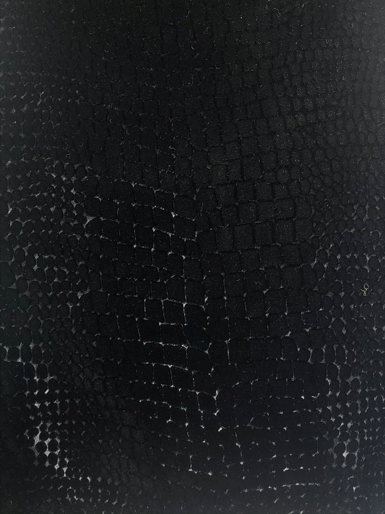 May include: Black textured fabric with a repeating pattern of small squares and circles.