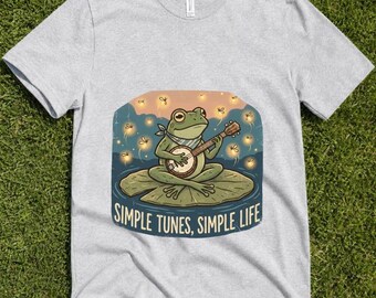 カエルのバンジョーTシャツ、風変わりなフォークアート風池のアパレル、シンプルな生活Tシャツ