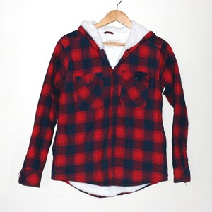 May include: Red and black plaid flannel shirt with a white sherpa lining and a hood.
