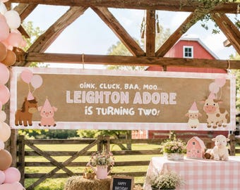 May include: A rectangular banner with a tan background and pink gingham borders, featuring the text OINK, CLUCK, BAA, MOO... LEIGHTON ADORE IS TURNING TWO! and illustrations of a horse, pig, sheep, and cow wearing pink party hats.