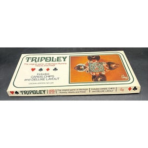 May include: A rectangular Tripoley board game box, Crown Edition No. 225. The cream-colored box features the title, card suit symbols, and text stating it includes cards, chips, and a deluxe layout. An illustration shows four people playing.