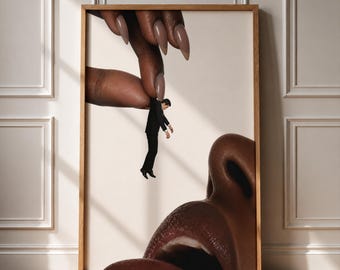 May include: A framed surrealist art print featuring a giant hand with long, light brown manicured nails holding a tiny person in a black suit. Below the hand, a large, detailed human nose and mouth are visible against a plain cream background.