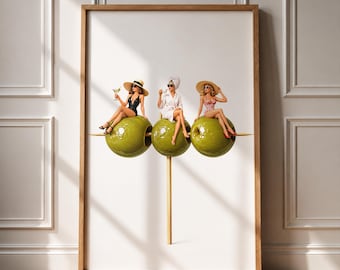 May include: A framed wall art print featuring three green olives on a toothpick, each topped with a miniature figure. The left figure wears a black swimsuit and sun hat, the center wears a white robe and towel, and the right wears a red patterned bikini.