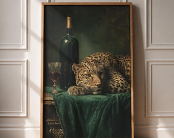 May include: A framed wall art print depicting a leopard resting on a table draped in a dark green velvet cloth. Beside the leopard stands a tall dark glass wine bottle and a crystal goblet filled with red wine, set against a dark background.