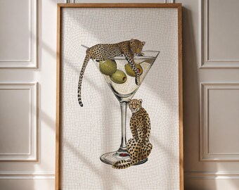 May include: A framed wall art print featuring a mosaic-style illustration of a martini glass containing three green olives. A leopard is draped over the rim of the glass, while a second leopard sits upright at the base of the glass stem.