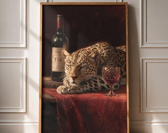 May include: A framed wall art print featuring a leopard resting on a red cloth surface next to a wine bottle and a filled glass. The leopard has a spotted coat and is positioned between the dark glass bottle and a stemmed wine glass.