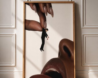 May include: A framed wall art print featuring a surreal composition of a large hand with long, light brown manicured nails holding a tiny person in a black suit above a large, dark-skinned nose and mouth against a plain off-white background.