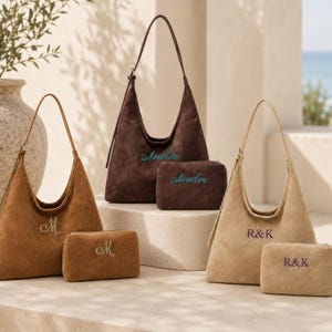 May include: Three sets of hobo-style shoulder bags and matching rectangular pouches in tan, dark brown, and light beige suede-like material. Each item features personalized embroidery: the letter M, the name Aurelia, and the initials R&K.