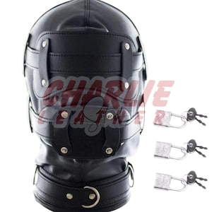 May include: A black leather hood featuring multiple adjustable straps with silver-toned metal rivets and a buckle closure at the neck. The hood includes three separate silver-toned padlocks with keys, each positioned to the right of the headpiece.