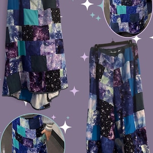 May include: A floor-length patchwork skirt featuring a variety of square fabric panels in shades of blue, purple, and black. The fabric patterns include galaxy prints with stars, nebulae, and solid blue tones. The skirt has an elastic waistband.