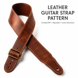 May include: A brown leather guitar strap with visible stitching and a brass-coloured metal buckle. The text LEATHER GUITAR STRAP PATTERN, Printable PDF, Adjustable, and Instant Download is displayed in black lettering next to the strap.