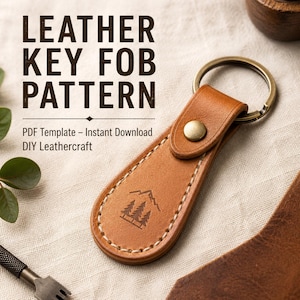 May include: A tan leather key fob with a metal ring and a snap button closure. The leather features a stamped mountain and pine tree graphic and light-coloured stitching. Text reads: LEATHER KEY FOB PATTERN, PDF Template - Instant Download DIY Leathercraft.
