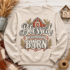 May include: A beige crewneck sweatshirt featuring a graphic print of a red barn, wheat stalks, and the text "Blessed BEYOND THE BARN" in black and white lettering. The design includes decorative flourishes and a rustic farm-inspired aesthetic.