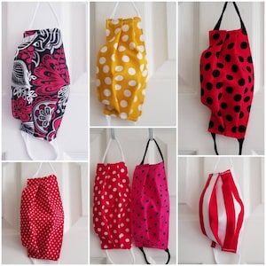 May include: A collection of ten fabric face masks in various patterns. The masks are made of cotton and have a variety of colors and designs, including polka dots, stripes, and floral patterns.