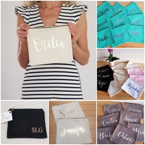 May include: A collection of personalized cosmetic bags in various colors and fabrics. The bags feature names like Otilia, Szi, Jennifer, Sylvia, Jessica, Cecilia, Annie, Beck, Chloe, and Alica. The bags are perfect for storing makeup, toiletries, or other small items.