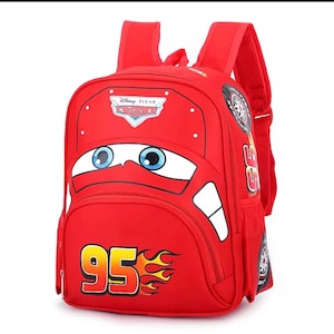 May include: A bright red backpack featuring the Disney Pixar Cars character Lightning McQueen. The front displays large blue eyes, the number 95 with orange flames, and the Cars logo. It includes adjustable shoulder straps and side pockets.