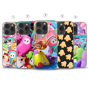 May include: Five smartphone cases featuring colourful Fall Guys character designs. Case 1 shows a crowd of characters, 2 features a pink character, 3 displays a toucan and lion costume, 4 has a pattern of yellow characters on black, and 5 shows a game level.