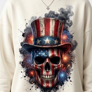 May include: A cream-colored crewneck sweatshirt featuring a graphic print of a human skull wearing a top hat. Both the skull and the hat are decorated with the red, white, and blue stars and stripes of the American flag, surrounded by dark smoke and fireworks.