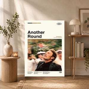 May include: A vertical rectangular poster titled Another Round featuring a film still of a man in a black suit looking upward. The design includes black text on a cream background, listing the director Thomas Vinterberg and cast members.