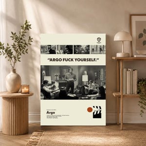 May include: A vertical rectangular poster featuring a black and white film scene from Argo, with the text "ARGO FUCK YOURSELF." at the top. The design includes a small Warner Bros logo, a film clapperboard icon, and credits for the movie Argo.