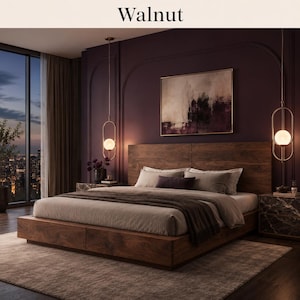 May include: A walnut platform bed frame with a large headboard, featuring a low-profile design with integrated storage drawers. The bed is dressed in neutral-toned bedding and a dark throw blanket, positioned between two marble-topped nightstands.