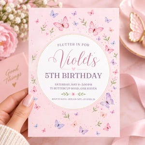 Pode incluir: Um cartão de convite de aniversário retangular com fundo rosa claro, apresentando borboletas em aquarela e pequenos ramos verdes. O centro contém um círculo branco com o texto: Flutter in for Violet's 5th Birthday, Saturday, May 9, 3:00 PM, 72 Buttercup Road, Oak Haven, RSVP to Maya (555) 018-3075 by April 28.