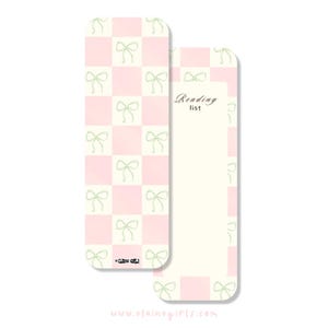 May include: Two bookmarks. One features a pink and white checkered pattern with green bow accents. The other bookmark has a cream background with the words "Reading list" and a space for notes. The website address "www.elainegirls.com" is at the bottom.
