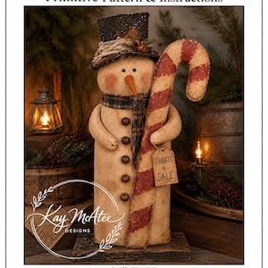 May include: A 24-inch tall fabric snowman figurine wearing a dark top hat and a plaid scarf, holding a large red and white striped candy cane. A small rectangular tag hanging from the candy cane features the text Treats 4 Sale in black ink.