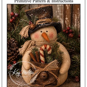 May include: A fabric snowman doll wearing a dark brown top hat with a small bell and pine sprigs. The snowman holds a bucket containing a candy cane and cinnamon sticks. The text reads Rusty Primitive Pattern & Instructions 18" Tall By Kay McAtee Designs.