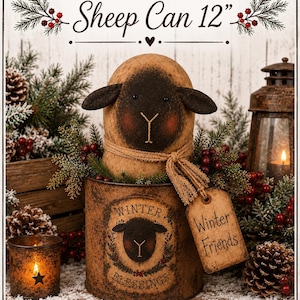 May include: A decorative sheep figurine with a black face and tan body, wearing a tan fabric scarf and a tag labelled Winter Friends. It sits in a distressed brown metal can labelled Winter Blessings, measuring 12 inches in height.