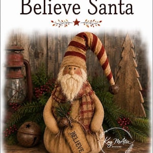May include: A fabric Santa figurine with a long, drooping red and tan striped hat topped with a small bell. The figure has a white beard, a plaid scarf, and holds a tan tag printed with the word BELIEVE. The text Believe Santa is above.