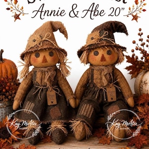 May include: Two 50.8 cm scarecrow dolls named Annie and Abe, featuring burlap hats, button eyes, and triangular noses. They wear brown textured clothing with patches and small tags that read Happy Fall. The text Sweet Harvest is above them.