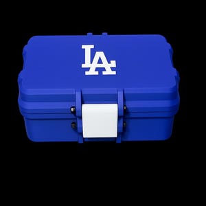 May include: A rectangular blue storage case with a hinged lid and a central white latch. The top of the case features the white interlocking LA logo. The container has a structured, durable design with visible hinges and a smooth, matte finish.