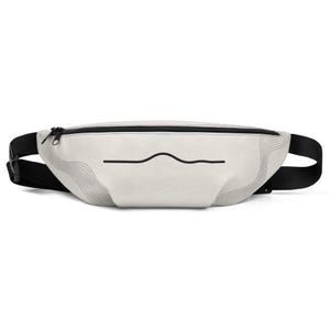 May include: A light gray fanny pack featuring a black zipper closure and a black adjustable strap. The front of the bag displays a minimalist black line graphic that curves in the center, complemented by subtle, thin gray wavy line patterns.