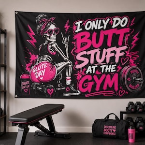May include: A black wall tapestry featuring a skeleton wearing a pink headband and heart-shaped sunglasses, with the text I ONLY DO BUTT STUFF AT THE GYM in pink and white. The design includes a shaker bottle, a barbell plate, and pink hearts.