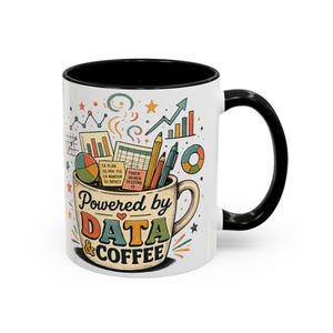 Pode incluir: Uma caneca de cerâmica branca com asa e rebordo interior pretos. O exterior apresenta uma ilustração colorida de material de escritório e gráficos que emergem da caneca, com o texto "Powered by DATA & COFFEE" numa fonte de estilo retro.