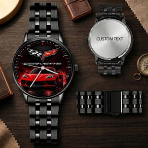 May include: A black metal wristwatch featuring a red Corvette sports car graphic and logo on the dial. The watch has a link bracelet and a silver-toned case back with the text CUSTOM TEXT. The design includes a tachymeter scale around the dial.