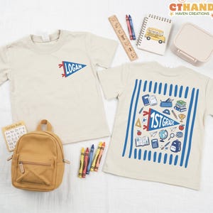 May include: Two beige t-shirts with school-themed graphics. One shirt features a blue pennant with the name Logan. The other displays a large blue pennant reading 1st Grade surrounded by illustrations of books, a globe, a backpack, and school supplies.