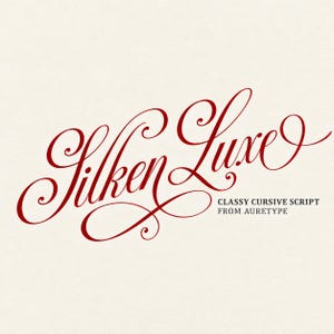 May include: The text Silken Luxe is written in a deep red, decorative cursive script font. Below this, the text CLASSY CURSIVE SCRIPT FROM AURETYPE is printed in a smaller, black, sans-serif font against a plain, light-colored background.