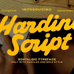May include: A graphic design display featuring the yellow text Hardine Script in a bold, cursive font. Additional white text reads INTRODUCING, TRADEMARK, REGISTERED, NOSTALGIC TYPEFACE, and ONLY WITH REGULAR AND BOLD STYLE against a tan hat background.
