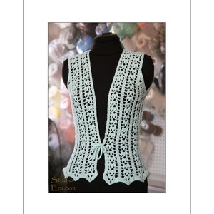 May include: A light green, open-front crochet vest displayed on a black mannequin. The vest features a delicate, openwork design with a scalloped hem and a tie closure. The Studio Era.com logo is visible in the lower left corner.