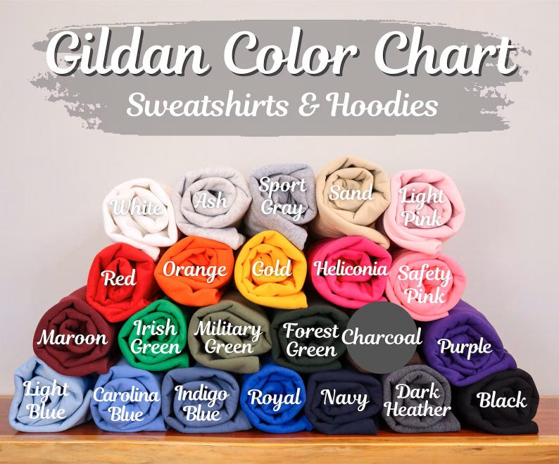 May include: A Gildan color chart for sweatshirts and hoodies displaying twenty-four rolled fabric samples in various colors including white, ash, sport gray, sand, light pink, red, orange, gold, heliconia, safety pink, maroon, irish green, military green, forest green, charcoal, purple, light blue, carolina blue, indigo blue, royal, navy, dark heather, and black.
