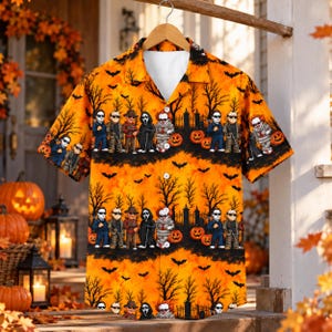 May include: A short-sleeve button-down shirt in bright orange with a repeating pattern of black silhouettes of bare trees, flying bats, and jack-o'-lanterns. The print features rows of cartoon horror movie characters standing in a graveyard.
