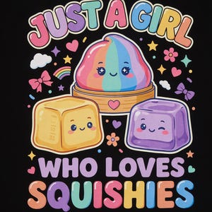 May include: A black graphic print featuring the text JUST A GIRL WHO LOVES SQUISHIES in colorful letters. The design includes a rainbow-colored rounded squishy in a wooden basket, a yellow cube squishy, and a purple cube squishy, all with faces.