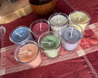 Seven scented candles in glass jars