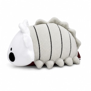 May include: A plush toy shaped like a segmented creature with a white head, a black circular eye, and a light gray body featuring dark vertical stripes. The toy has a ruffled dorsal ridge, multiple small rounded legs, and a dark red underside.