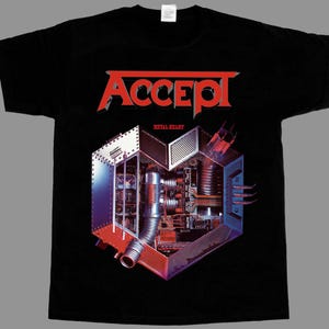 May include: A black short-sleeve t-shirt featuring the red text "ACCEPT" at the top and "METAL HEART" below it. The central graphic depicts a mechanical heart structure composed of metallic components, circuit boards, and industrial pipes.