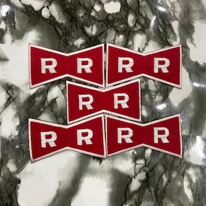 May include: Five red, bow-tie shaped embroidered patches with white stitched borders. Each patch features the letter R in white, with the top two patches displaying four Rs, the middle patch displaying two Rs, and the bottom two patches displaying four Rs.